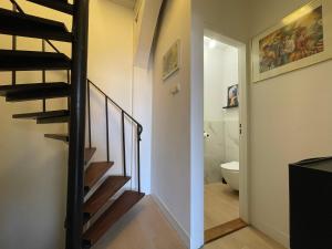 a staircase leading to a bathroom with a toilet at Bedroom Dordrecht Centrum - La Focaccina in Dordrecht