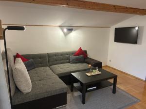 a living room with a couch and a table at Ferienwohnung Diwoky in Sankt Gilgen