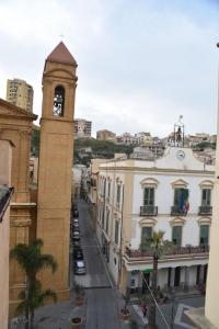 a building with a clock tower in a city at Suite Romantica con Jacuzzi e Sauna in Porto Empedocle