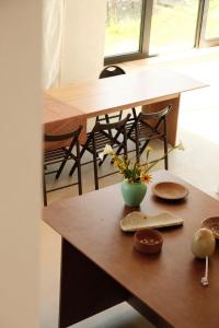 a table with a vase of flowers on it at Dadi House Martvili in Martvili +10 photos