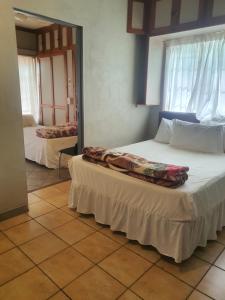 a bedroom with two beds in a room at Valleycenter guestlodge in Johannesburg +21 photos