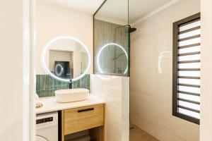 a bathroom with a sink and a mirror at La Kaz Amiral in Saint-Pierre +33 photos