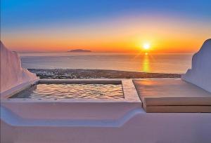 a view of the sunset from a terrace with a pool at Martynou View in Pyrgos
