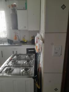 a kitchen with a stove top oven next to a refrigerator at Casa São Thomé in São Thomé das Letras +4 photos