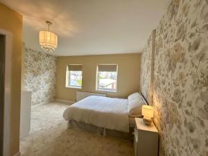 a bedroom with a bed and a stone wall at An Teach Ban in Tralee