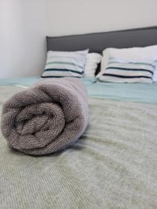 a blanket laying on top of a bed at Akvamarin Downtown Apartman in Székesfehérvár +44 photos