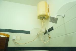 a light attached to a wall in a bathroom at T-Nova Guest House in Trincomalee +52 photos