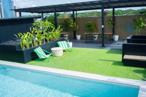 a patio with chairs and a swimming pool on a building at Canopyproperties in Manila