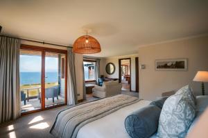 a bedroom with a bed and a view of the ocean at Casa Molino Hotel Boutique & Restaurant Puerto Varas in Puerto Varas +63 photos