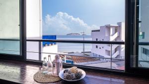 a table with a view of the ocean from a window at Geoje Memory Kidspoolvilla in Geoje +22 photos