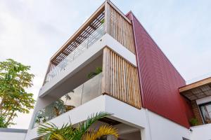 an external view of a house with wooden balconies at La Kaz Amiral in Saint-Pierre