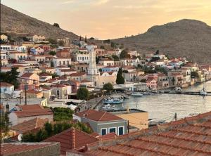 a view of a town with boats in the water at Aegean soul apartments in Halki