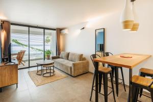 a living room with a couch and a table at La Kaz Amiral in Saint-Pierre