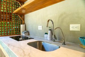 a kitchen with a sink and a counter top at Serenity Bungalow in Cocles