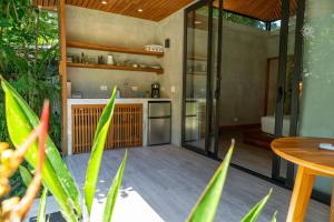 a kitchen and dining area of a house with plants at Serenity Bungalow in Cocles +24 photos