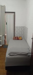 a bed sitting in a room with at pousada popular in Barreiras