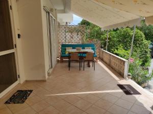 a patio with a table and chairs on a balcony at Seaside villa in Eretria in Eretria