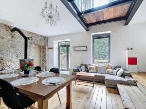 a living room with a table and a couch at Le Moulin Hochet in Les Pieux