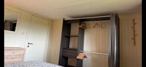 a room with a bed and a closet and a door at Le Caroline du Nord in Tenneville +25 photos