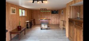 a room with wooden walls and a stove in it at Le Caroline du Nord in Tenneville