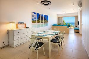 a kitchen and dining room with a table and chairs at Ocean Point B3 in Pointe aux Piments