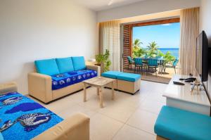 a living room with a couch and a table at Ocean Point B3 in Pointe aux Piments