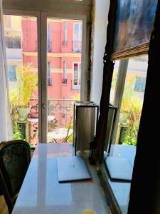 a room with a table and a large window at Nice - Stylish apartment downtown in Nice