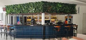 a bar with plants on the wall behind it at Gazipasa Star Otel in Side