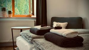 two beds with towels on them in a room at Penzion Jiřičná in Jiřičná