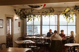 a group of people sitting at tables in a restaurant at Orcas Hotel in Orcas