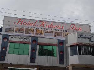 a building with a sign on top of it at Hotel kabras' inn in Mount Ābu