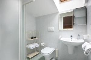 a white bathroom with a toilet and a sink at Casa Del Noce in Rovereto +45 photos
