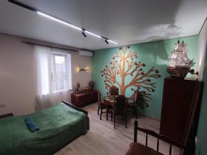 a bedroom with a bed and a dining room with a table at Our Village in Ashtarak