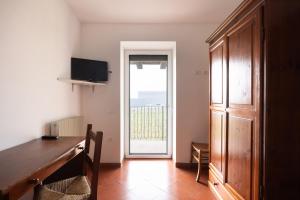 a room with a door leading to a balcony at Casa Del Noce in Rovereto