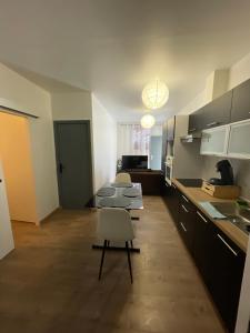 a kitchen with a table and chairs in a room at Villejuif IGR in Villejuif +5 photos