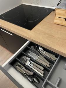 a drawer filled with knives and other kitchen utensils at Villejuif IGR in Villejuif