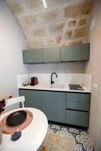 a small kitchen with a sink and a counter at Aria d'amare in Mola di Bari +18 photos