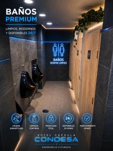 a sign for a bathroom with urinals and toilets at Hotel Capsula Condesa in Mexico City
