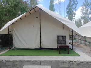 a tent with a chair in front of it at Town Front Camping in Leh +2 photos