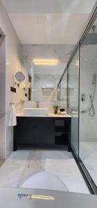 a bathroom with a tub and a sink and a shower at Anona Beachfront Villa in Filadu
