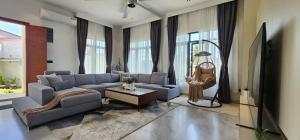 a living room with a couch and a table at Anona Beachfront Villa in Filadu