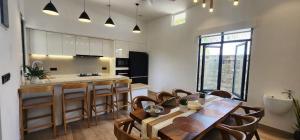 a kitchen and dining room with a table and chairs at Anona Beachfront Villa in Filadu +10 photos
