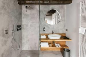 a bathroom with a shower with a sink and a mirror at Cascina Belvedì in Clanezzo +60 photos