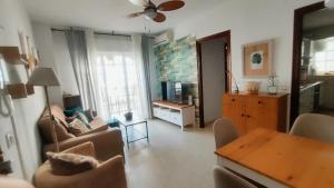 a living room with a couch and a table at PISO AURORA in Barbate