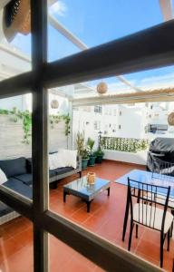 a living room with a couch and a table at PISO AURORA in Barbate