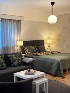 a living room with a bed and a couch at Hamina Bastion Apartments in Hamina