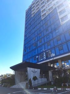 a large tall building with a sign in front of it at Olimp Sea View Studio in Olimp