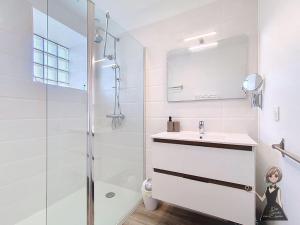 a white bathroom with a sink and a shower at La petite Maison Rouge in Igon +21 photos