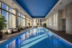 a swimming pool in a hotel with a blue ceiling at Mandarin Oriental, New York in New York