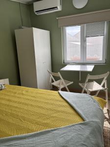 a bedroom with a bed and a window and a table at Home for two in Igal